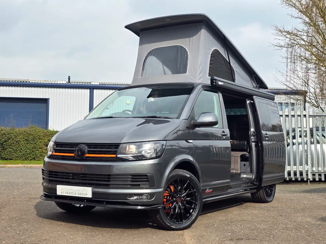 A gray VW campervan with roof